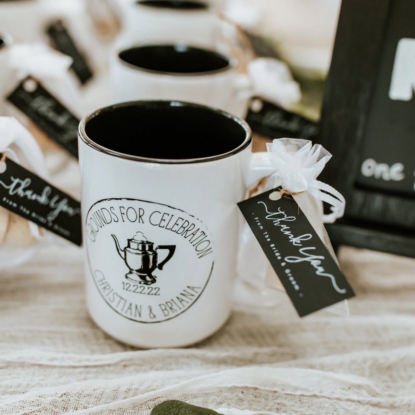 Personalized "Grounds for Celebration" wedding favor mugs with thank-you tags