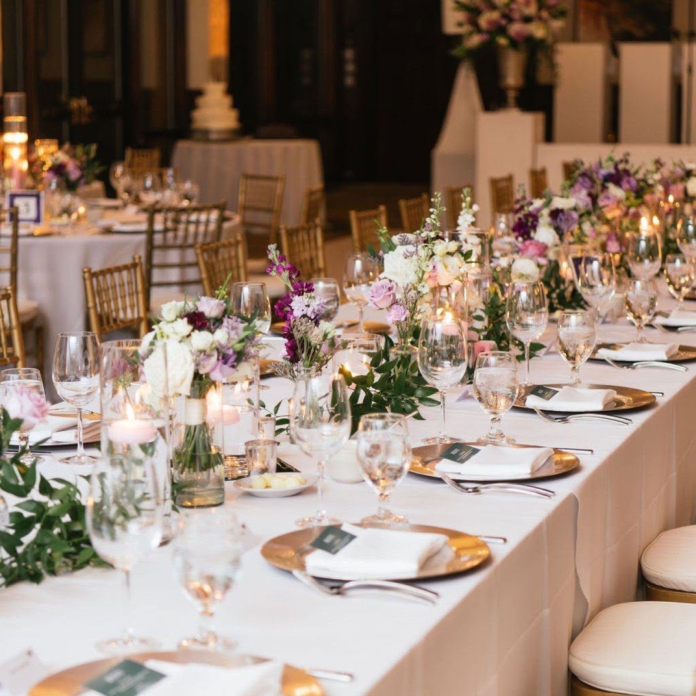 An elegant wedding tablescape with lavender florals and candlelight